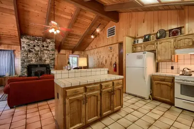 a kitchen with wooden cabinets and a white refrigerator at Bordentown West in Wawona
