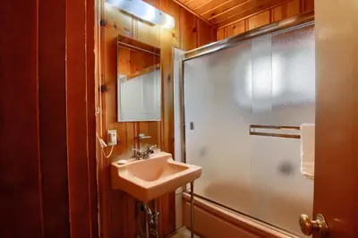 a bathroom with a sink and a shower at Simmons Den in Wawona