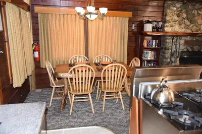 a dining room with a wooden table and chairs at Sequoia in Wawona