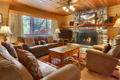 a living room with couches and a fireplace at Walk-A-Bout in Wawona