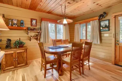 a dining room with a wooden table and chairs at Walk-A-Bout in Wawona