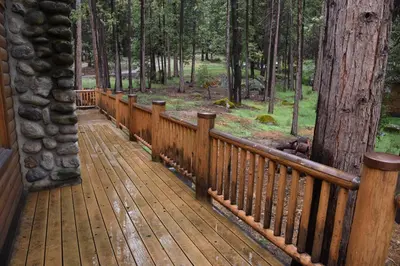 a wooden deck in the middle of a forest at Half Dome in Wawona