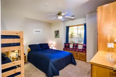 a bedroom with a bed and a ceiling fan at Miller's Landing in Wawona