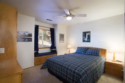 a bedroom with a bed and a ceiling fan at Miller's Landing in Wawona