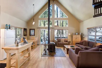 a living room with a couch and a table at Wawona Chalet in Wawona