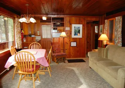 a living room with a table and a couch at Nugent's Nest in Wawona