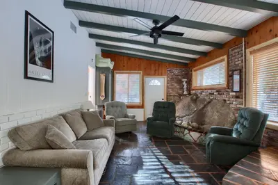 a living room with a couch and two chairs at The Little Creek Cabin in Wawona