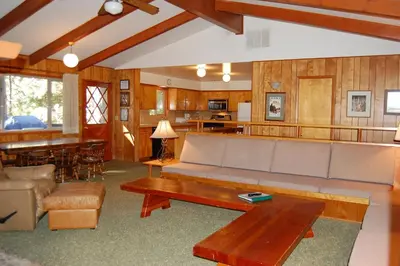 a living room with a couch and a table at Yosemite Mountain Lodge in Wawona