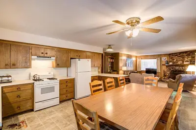 a kitchen with a wooden table and a ceiling fan at Deer Hollow in Wawona