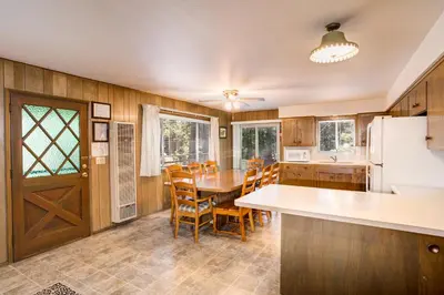 a kitchen and dining room with a table and chairs at Deer Hollow in Wawona