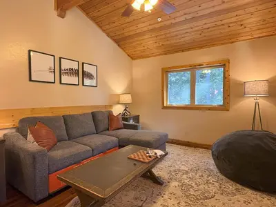 a living room with a couch and a table at Lily of the Valley - Big Wall, Yosemite Day Use Reservations, Breakfast, Forest View and WiFi in Yosemite West