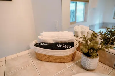 two baskets of towels on a counter in a bathroom at Beautiful and Spacious Home - Walk to Lake & Beach in Tahoma