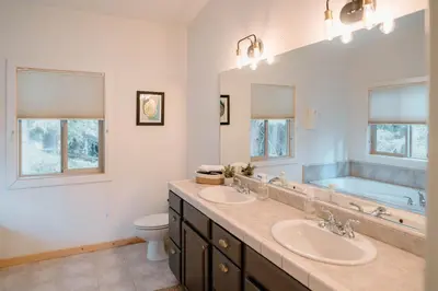 a bathroom with two sinks and a bath tub at Beautiful and Spacious Home - Walk to Lake & Beach in Tahoma