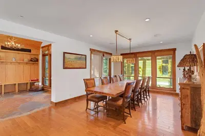 a dining room with a wooden table and chairs at 4BR Cabin with Hot Tub – Ultimate Truckee Escape cabin in Truckee