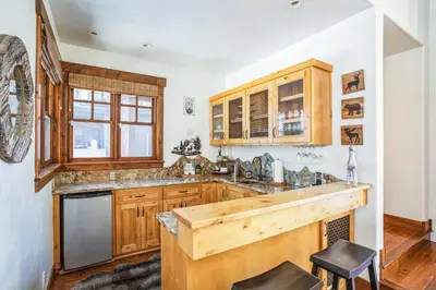 a kitchen with wooden cabinets and a counter at 4BR Cabin with Hot Tub – Ultimate Truckee Escape cabin in Truckee