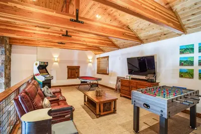 a living room with a couch and a table at 4BR Cabin with Hot Tub – Ultimate Truckee Escape cabin in Truckee