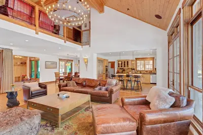 a living room with a couch and a table at 4BR Cabin with Hot Tub – Ultimate Truckee Escape cabin in Truckee