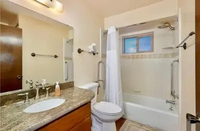 a bathroom with a sink and a toilet and a tub at ManVee at Yosemite in Fish Camp