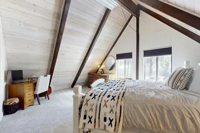 a bedroom with a bed and a desk in a room at Sioux Serenity in South Lake Tahoe