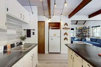 a kitchen with a sink and a refrigerator at Sioux Serenity in South Lake Tahoe