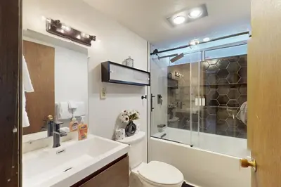 a bathroom with a toilet and a sink and a shower at Sioux Serenity in South Lake Tahoe