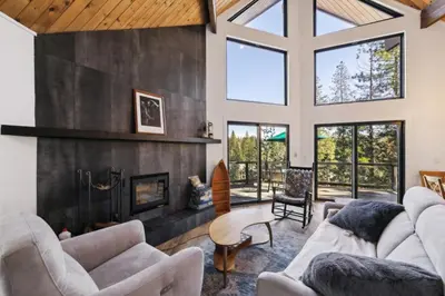 a living room with couches and a fireplace at Golden Peak Cabin home in Groveland