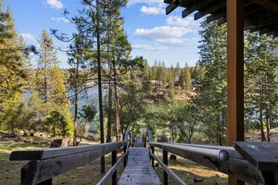 a wooden walkway in a forest with people walking on it at Golden Peak Cabin home in Groveland