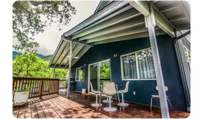 a house with a deck with chairs on it at Alta Peak House in Three Rivers