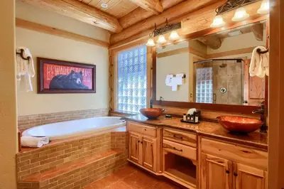 a bathroom with a tub and two sinks and a bath tub at Yosemite's Luxury Estate at The Redwoods in Yosemite 2349 in Wawona