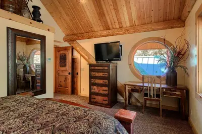 a bedroom with a bed and a desk and a mirror at Yosemite's Luxury Estate at The Redwoods in Yosemite 2349 in Wawona