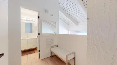 a white room with a bench and a window at Walk to Canyon Lodge Ski back Modern Space in Mammoth Lakes