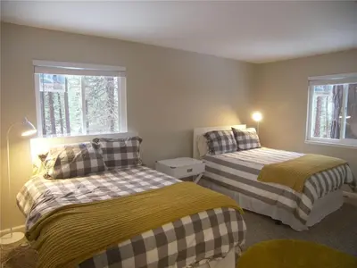 two beds in a room with two windows at 725 Lynda Court Incline Village Nevada USA in Incline Village