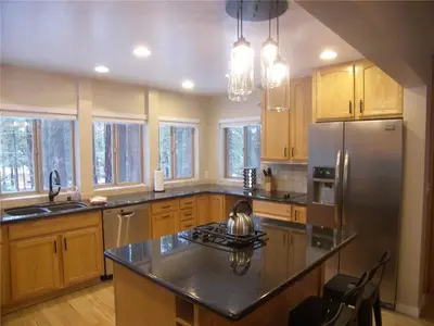 a kitchen with wooden cabinets and a stainless steel refrigerator at 725 Lynda Court Incline Village Nevada USA in Incline Village