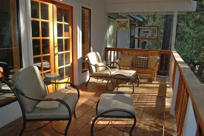 a porch with chairs and a bench on it at Doyle's Mountain in Wawona