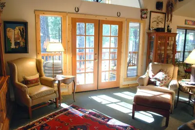 a living room with chairs and sliding glass doors at Doyle's Mountain in Wawona