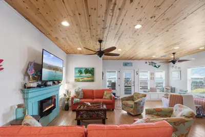 a living room with a couch and a fireplace at Mermaid Cove PA - Beach Gear Credit Included in Fresno