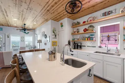 a kitchen with a sink and a counter top at Mermaid Cove PA - Beach Gear Credit Included in Fresno