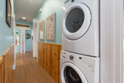 a washer and dryer in a room with a hallway at Mermaid Cove PA - Beach Gear Credit Included in Fresno