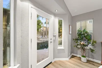 a hallway with a door and a potted plant at Casita Andrade in Turlock