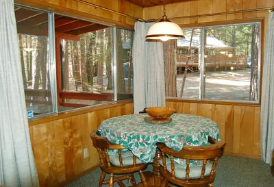 a table with a bowl on it in a room with a window at Cozy 2Br Retreat with Scenic Deck & Outdoor Dining in Wawona