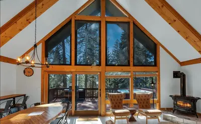 a dining room with a large glass window at Remodeled 4BDR Cabin with AC Lake Views Hot-Tub Bunk Room Excellent Location in Kings Beach