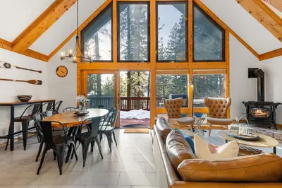 a living room with a couch and a table at Remodeled 4BDR Cabin with AC Lake Views Hot-Tub Bunk Room Excellent Location in Kings Beach