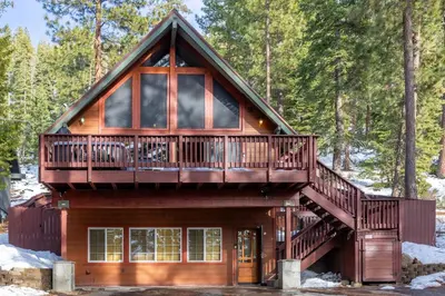 a log cabin with a large balcony and a deck at Remodeled 4BDR Cabin with AC Lake Views Hot-Tub Bunk Room Excellent Location in Kings Beach