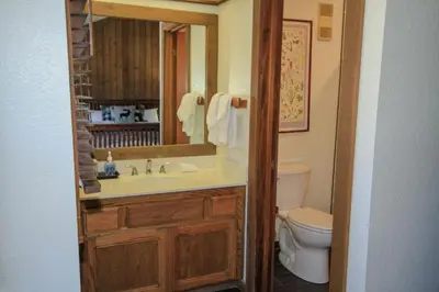 a bathroom with a sink and a toilet and a mirror at Mountainback 19 Loft Den in Mammoth Lakes