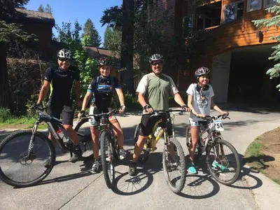 a group of four people standing with their bikes at Mountainback 19 Loft Den in Mammoth Lakes