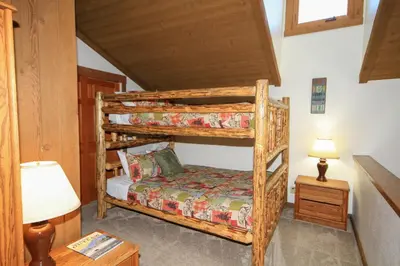 a bedroom with two bunk beds in a cabin at Mountainback 19 Loft Den in Mammoth Lakes