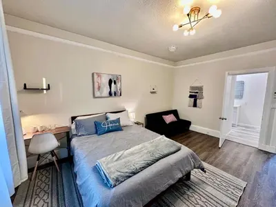 a bedroom with a bed and a desk and a chair at Cozy Tower Hideaway in Fresno