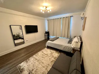 a bedroom with a bed and a mirror and a tv at Cozy Tower Hideaway in Fresno