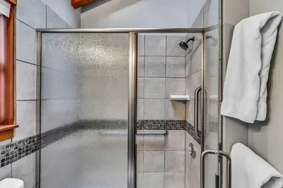 a shower with a glass door in a bathroom at Cozy Truckee Vacation Rental with Fireplace & Deck in Truckee