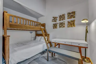 a small bedroom with a bunk bed and a desk at Cozy Truckee Vacation Rental with Fireplace & Deck in Truckee